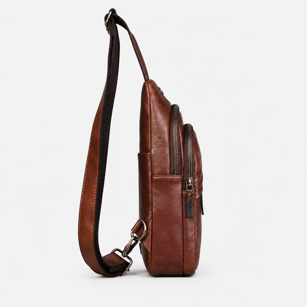 Side view of deep brown leather fanny pack showing slim 7cm profile, structured leather body, and adjustable strap
