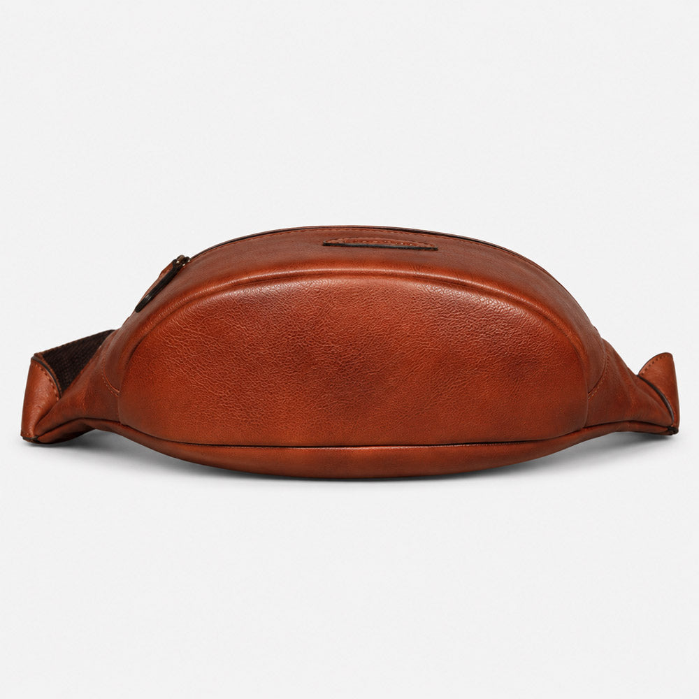 Bottom view of brown full-grain leather waist bag showing structured base, compact shape, and reinforced stitching