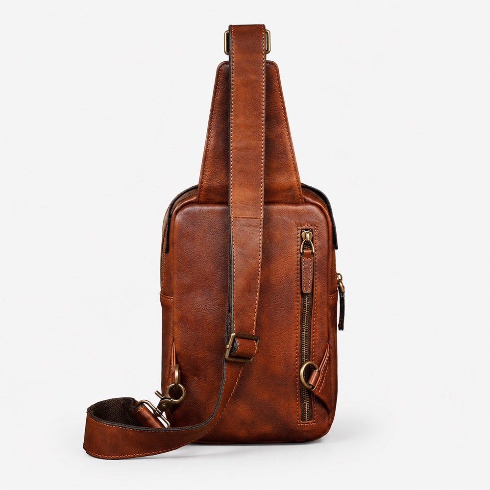 Back view of brown leather waist bag with rear zipper pocket, leather strap anchors, and vintage full-grain texture