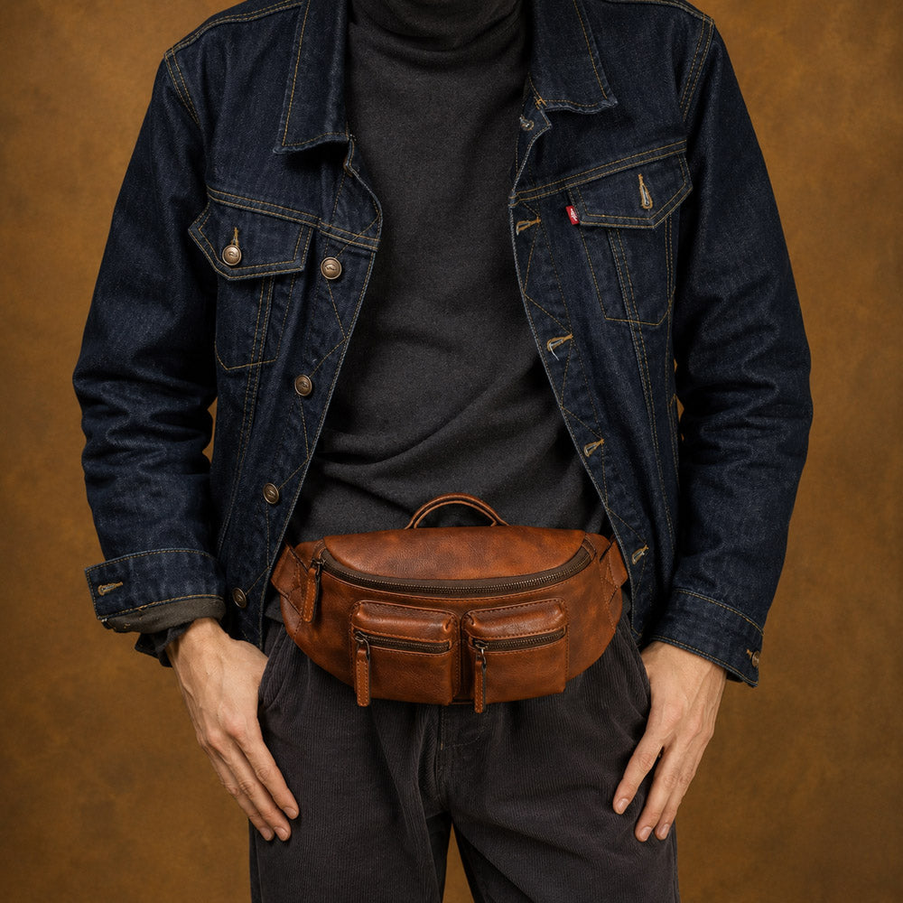 Brown leather designer bum bag worn crossbody on model, showing compact concealed carry styling for urban daily use
