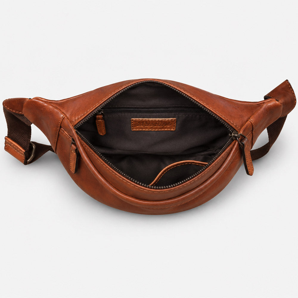 Open mens leather waist bag showing organized interior storage for a 7-inch smartphone, wallet, cards, and daily essentials