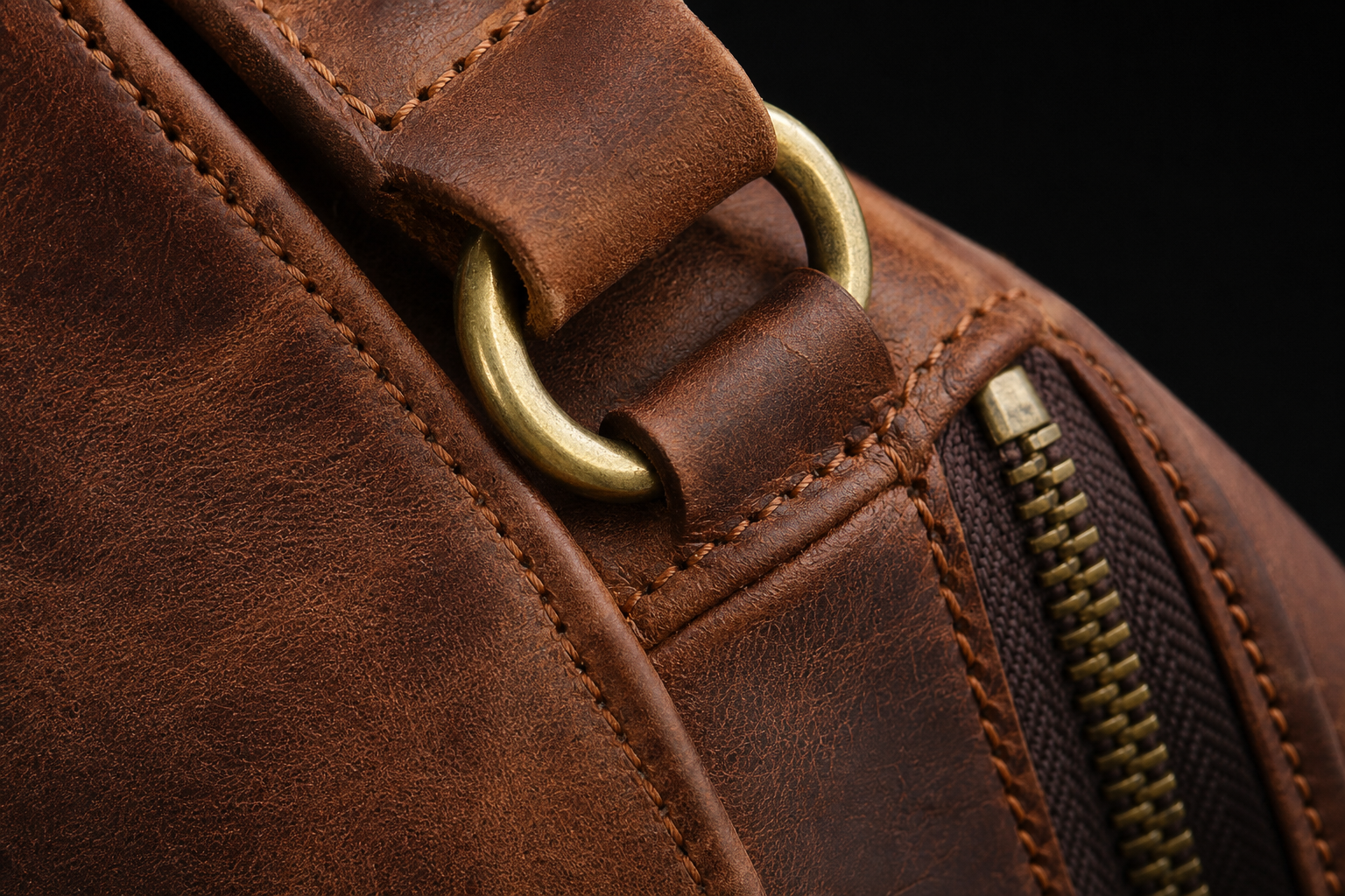 Close view of Carryfort leather grain, stitching, zipper and hardware